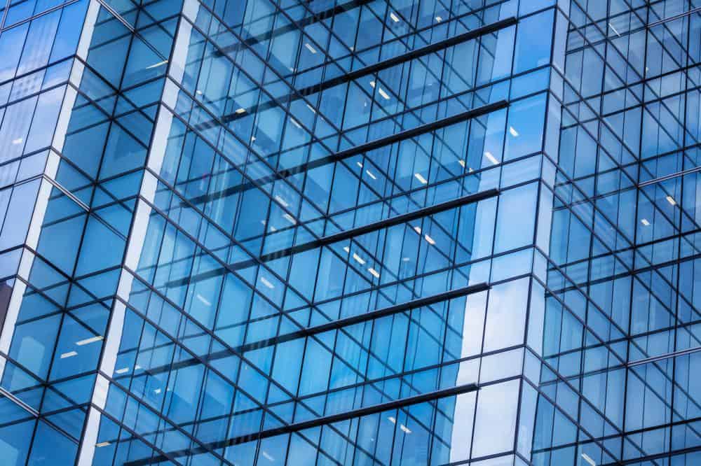 many glass windows of a tall corporate building